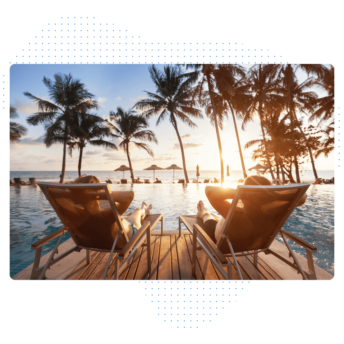 Two people relax on lounge chairs by a pool, facing a sunset over the ocean.